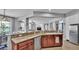 Kitchen features a breakfast bar with granite countertops, dark cabinets, and stainless appliances at 2468 Winnipeg Dr, Lakeland, FL 33805