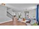 Well-lit living room featuring wood floors, stairs, neutral-toned furnishings, and stylish decor at 2468 Winnipeg Dr, Lakeland, FL 33805