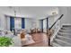 Bright living room boasts wood floors, gray walls, staircase, and stylish furniture at 2468 Winnipeg Dr, Lakeland, FL 33805