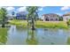 Tranquil pond view with trees and landscaping that surrounds the home at 2468 Winnipeg Dr, Lakeland, FL 33805