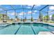 Beautiful screened pool and spa with cascading waterfalls and a serene lake view at 2468 Winnipeg Dr, Lakeland, FL 33805