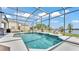 Inviting screened-in pool with waterfall feature, beautiful blue water, and lake view at 2468 Winnipeg Dr, Lakeland, FL 33805