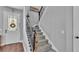 Stairway featuring hardwood floors, carpeted steps and a decorative 