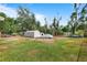 Expansive backyard featuring a storage shed, ample green space, and mature trees at 2520 Avenue C Sw, Winter Haven, FL 33880