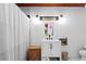 Bathroom featuring a white vanity, modern fixtures, and a tiled shower with curtain at 2520 Avenue C Sw, Winter Haven, FL 33880