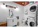 Bright bathroom with a modern vanity, stackable washer and dryer, and updated fixtures at 2520 Avenue C Sw, Winter Haven, FL 33880