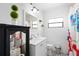 Bathroom with mosaic tile flooring, white vanity, and updated modern lighting at 2520 Avenue C Sw, Winter Haven, FL 33880