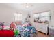 Comfortable bedroom featuring natural light and a ceiling fan with a vanity area at 2520 Avenue C Sw, Winter Haven, FL 33880