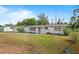 Quaint single-story home featuring a clean white exterior and a front yard at 2520 Avenue C Sw, Winter Haven, FL 33880