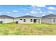 Grassy backyard with patio, ideal for outdoor activities and entertaining at 2611 San Marco Way, Winter Haven, FL 33884