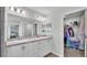 Spacious bathroom with double sinks, ample counter space, and a well-organized walk-in closet at 2611 San Marco Way, Winter Haven, FL 33884