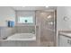 Bright bathroom showcasing a tiled tub and shower with neutral tile surround and modern fixtures at 2611 San Marco Way, Winter Haven, FL 33884