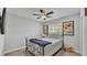 Cozy bedroom with ceiling fan, comfy bed, and window offering a serene view of neighborhood at 2611 San Marco Way, Winter Haven, FL 33884