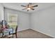 Neutral bedroom with ceiling fan, carpet, and a window letting in natural light at 2611 San Marco Way, Winter Haven, FL 33884