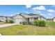 Lovely single-story home featuring a lush green lawn, two-car garage, and charming, well-maintained landscaping at 2611 San Marco Way, Winter Haven, FL 33884