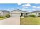 Beautiful single-story home showcasing a well-manicured lawn, an attached two-car garage, and neutral exterior paint at 2611 San Marco Way, Winter Haven, FL 33884