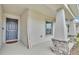 Welcoming front porch with stylish columns, stone accents, and a charming 'Casa es mi casa' sign at 2611 San Marco Way, Winter Haven, FL 33884