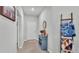 Inviting entryway with a blue console table, decorative mirror, and coat rack for a cozy feel at 2611 San Marco Way, Winter Haven, FL 33884