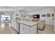 Open-concept kitchen with granite counters, stainless appliances, large island, and seamless flow to the living area at 2611 San Marco Way, Winter Haven, FL 33884