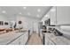 Beautiful kitchen with white cabinets, stainless steel appliances, stone countertops and an open layout at 2611 San Marco Way, Winter Haven, FL 33884
