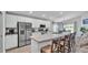 Modern kitchen with stainless steel appliances, stone countertops, and a kitchen island with seating at 2611 San Marco Way, Winter Haven, FL 33884