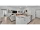 Spacious kitchen featuring granite countertops, an island with a sink and seating, and easy access to the living room at 2611 San Marco Way, Winter Haven, FL 33884