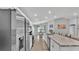 Bright, airy kitchen featuring stainless steel appliances, granite countertops, and an open layout to the dining area at 2611 San Marco Way, Winter Haven, FL 33884