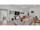 Inviting living room showcasing a sectional sofa, stylish decor, and seamless transition to adjacent kitchen and dining area at 2611 San Marco Way, Winter Haven, FL 33884