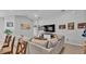 Comfortable living room boasts a large sectional sofa, contemporary decor, and ample natural light from a nearby window at 2611 San Marco Way, Winter Haven, FL 33884