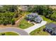 An aerial view shows the property's lot, complete with a home, lawn, mature trees, and landscaping at 2645 Delphi Hills Ct, Lakeland, FL 33812