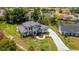 An aerial view shows the home's facade, driveway, lawn, landscaping, and surrounding neighborhood at 2645 Delphi Hills Ct, Lakeland, FL 33812