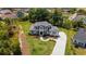 A high-angle shot shows the home's lawn, landscaping, hardscape, and the surrounding neighborhood at 2645 Delphi Hills Ct, Lakeland, FL 33812