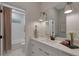 Well-lit bathroom with double sinks, a large mirror, and a tub/shower combo, combining functionality and style at 2645 Delphi Hills Ct, Lakeland, FL 33812