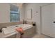 Luxurious soaking tub beneath a sparkling chandelier and a bright window at 2645 Delphi Hills Ct, Lakeland, FL 33812