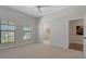 Spacious bedroom with large windows, ceiling fan, and two entrances, perfect for a comfortable and versatile living space at 2645 Delphi Hills Ct, Lakeland, FL 33812