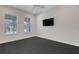 Spacious bedroom with large windows, ceiling fan, and a mounted flat-screen TV at 2645 Delphi Hills Ct, Lakeland, FL 33812