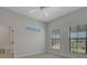 Bright bedroom features a ceiling fan and two large windows, offering plenty of natural light and ventilation at 2645 Delphi Hills Ct, Lakeland, FL 33812