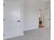 Bright bedroom with neutral walls, carpet, and white doors, offering a calming and modern aesthetic at 2645 Delphi Hills Ct, Lakeland, FL 33812