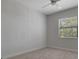 Light-filled bedroom with a ceiling fan and window, creating a comfortable and airy atmosphere at 2645 Delphi Hills Ct, Lakeland, FL 33812