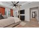 Bright and modern bedroom with a canopy bed, balcony access and entertainment center at 2645 Delphi Hills Ct, Lakeland, FL 33812