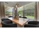 Dining room with large windows, modern light fixture, and black chairs at 2645 Delphi Hills Ct, Lakeland, FL 33812