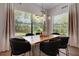 Dining room with large windows, modern light fixture, and black chairs at 2645 Delphi Hills Ct, Lakeland, FL 33812
