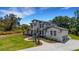 A daytime shot displays the home's exterior, manicured landscaping, and a winding walkway at 2645 Delphi Hills Ct, Lakeland, FL 33812