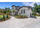 A beautiful shot of the front yard and home exterior, complete with lavish landscaping and a concrete drive at 2645 Delphi Hills Ct, Lakeland, FL 33812