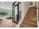 Bright foyer featuring a wine cellar, wood staircase, and access to the home's living room and outdoor pool area at 2645 Delphi Hills Ct, Lakeland, FL 33812