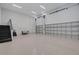 Spacious garage with three doors, neutral walls, sealed concrete floors, and a staircase to another level at 2645 Delphi Hills Ct, Lakeland, FL 33812
