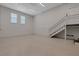 Spacious garage features painted block walls, two windows, stairs to upper level, and epoxy floor at 2645 Delphi Hills Ct, Lakeland, FL 33812
