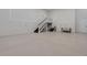 Spacious garage featuring epoxy floors, staircase, and ample room for storage at 2645 Delphi Hills Ct, Lakeland, FL 33812