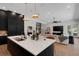 Open-concept kitchen with island, stainless steel sink, and view into the living room at 2645 Delphi Hills Ct, Lakeland, FL 33812