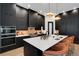 Kitchen featuring a large island with white countertop, black cabinets, and stainless steel appliances at 2645 Delphi Hills Ct, Lakeland, FL 33812
